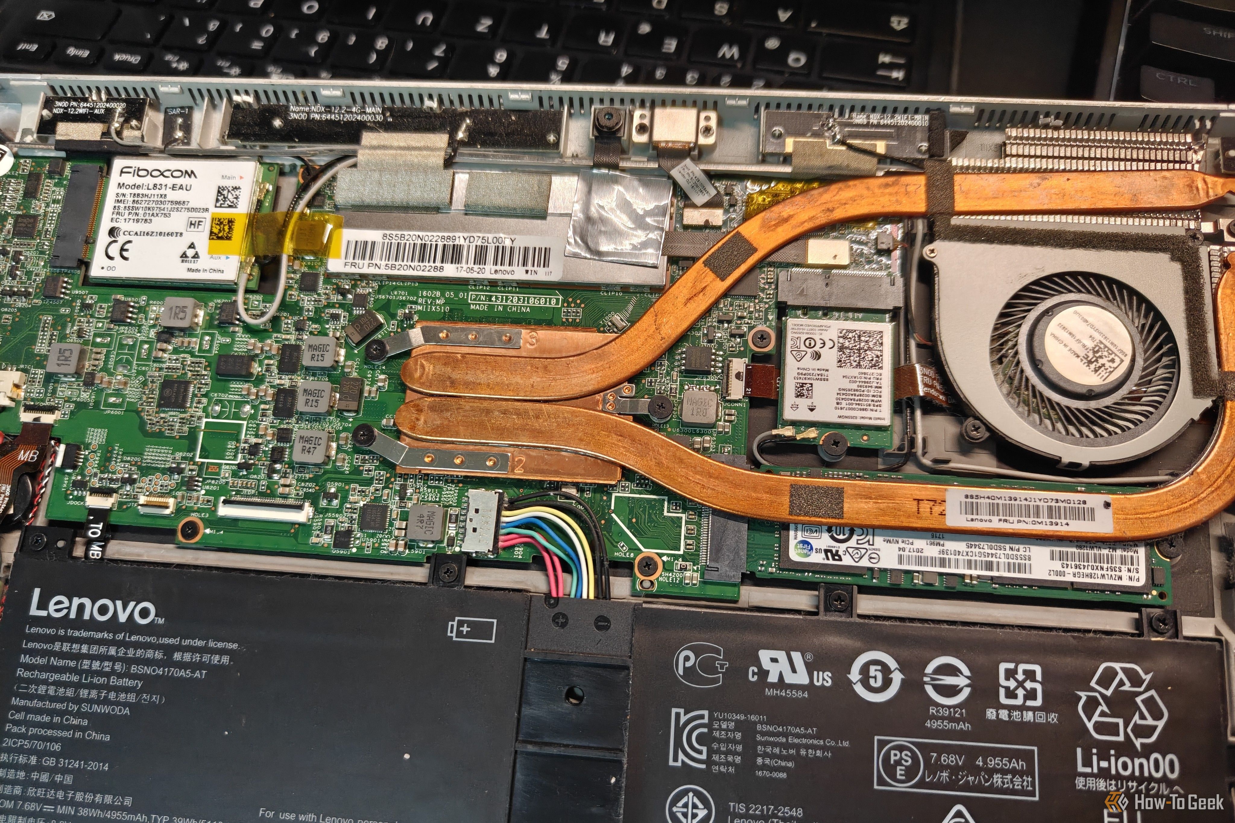 A disassembled laptop with weak cooling internals.