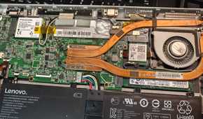 A disassembled laptop with weak cooling internals.