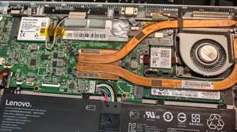 A disassembled laptop with weak cooling internals.