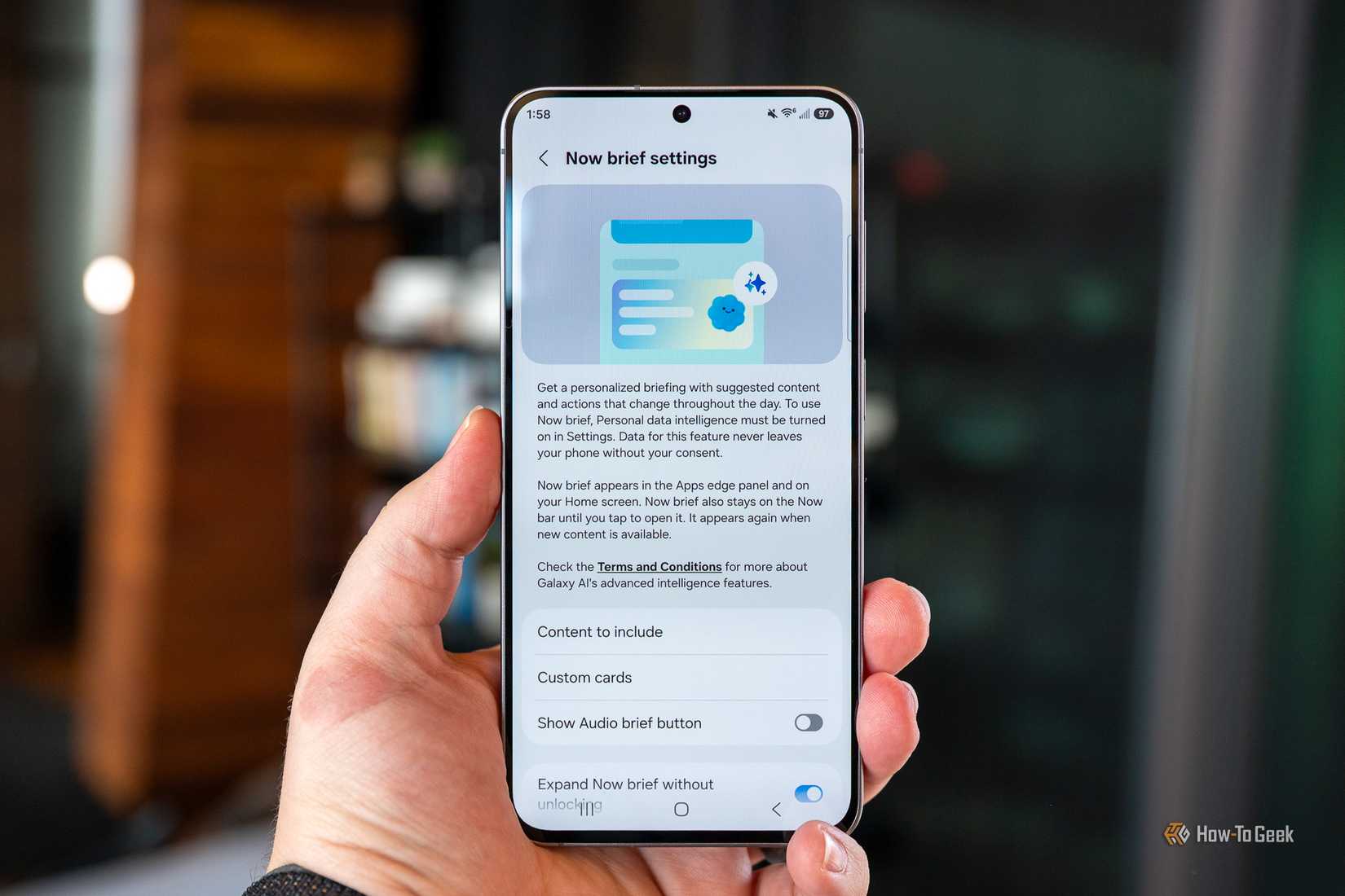 person holding the samsung galaxy s26 fe showing the now brief settings menu