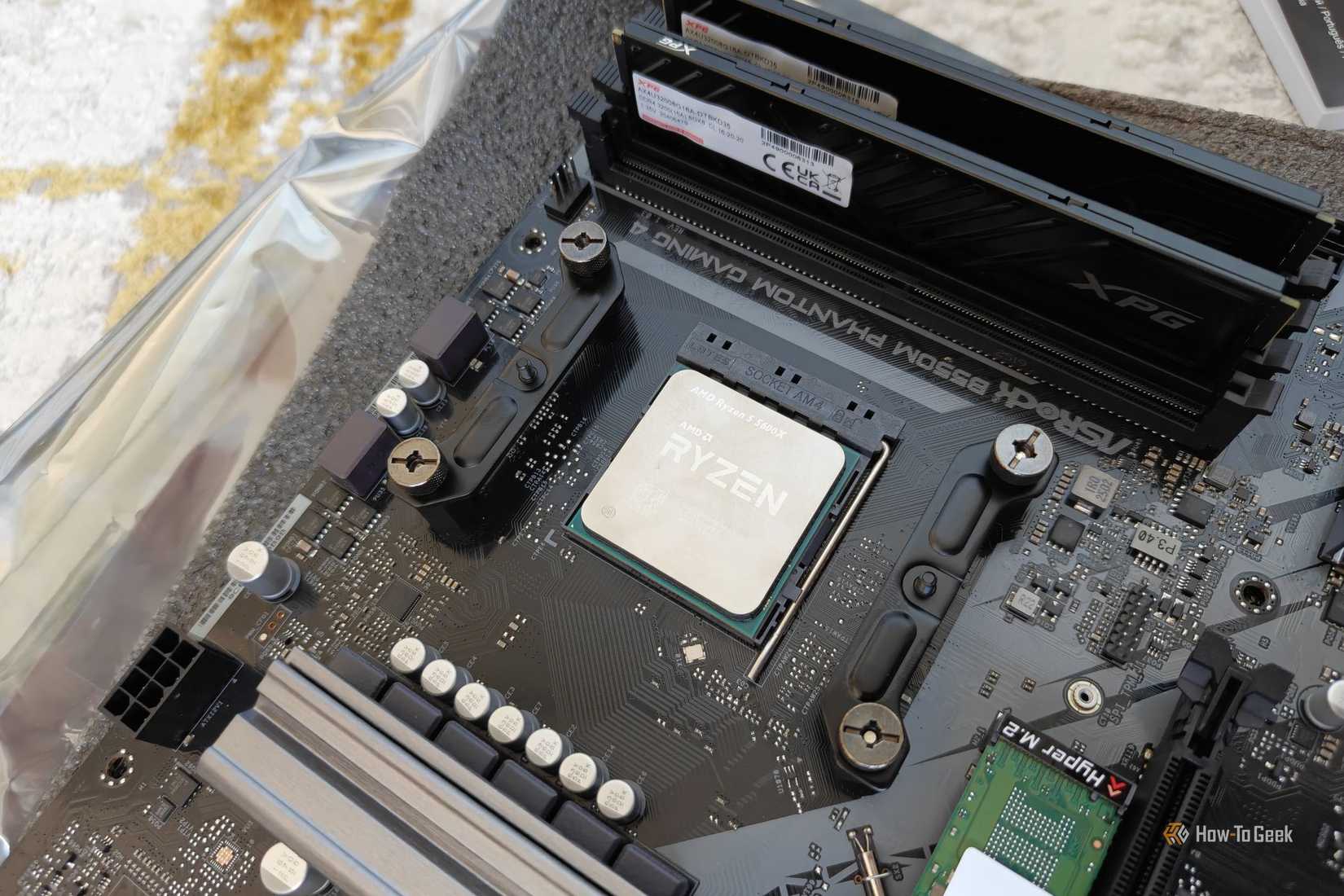The AMD Ryzen 5 5600X in a PC with some DDR4 RAM sticks next to it.