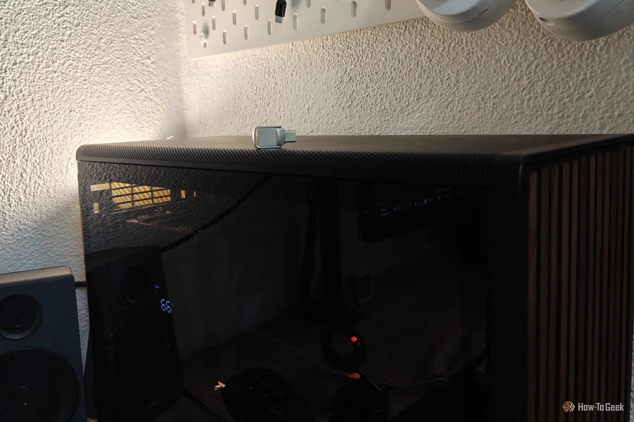 A tiny USB drive on top of a desktop PC.