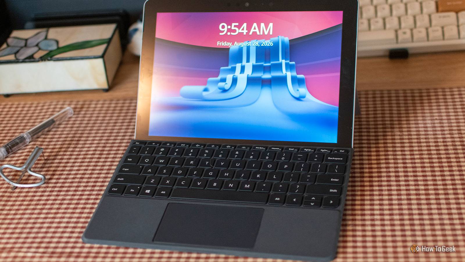 Side view of a locked Microsoft Surface Go running CachyOS Linux.