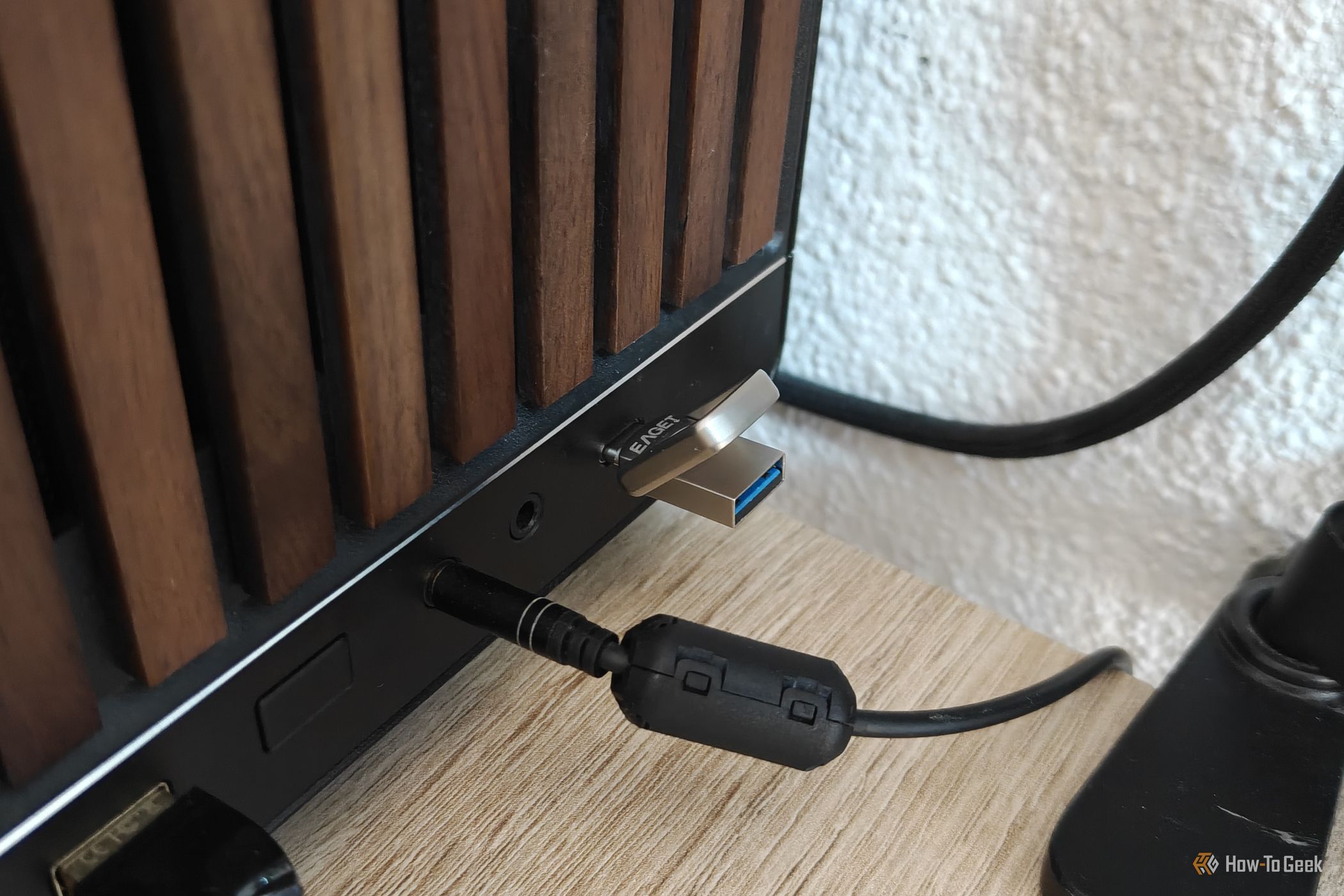 A tiny USB drive plugged into the USB-C port of a desktop computer.