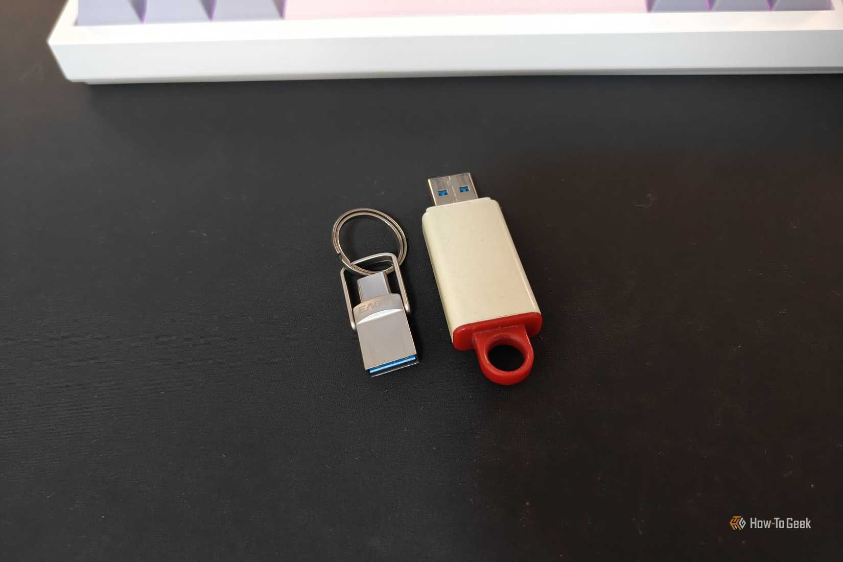 A tiny USB drive next to a regular-sized USB drive.