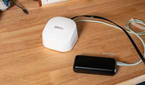 Top-down view of Eero Wi-Fi router and power bank.