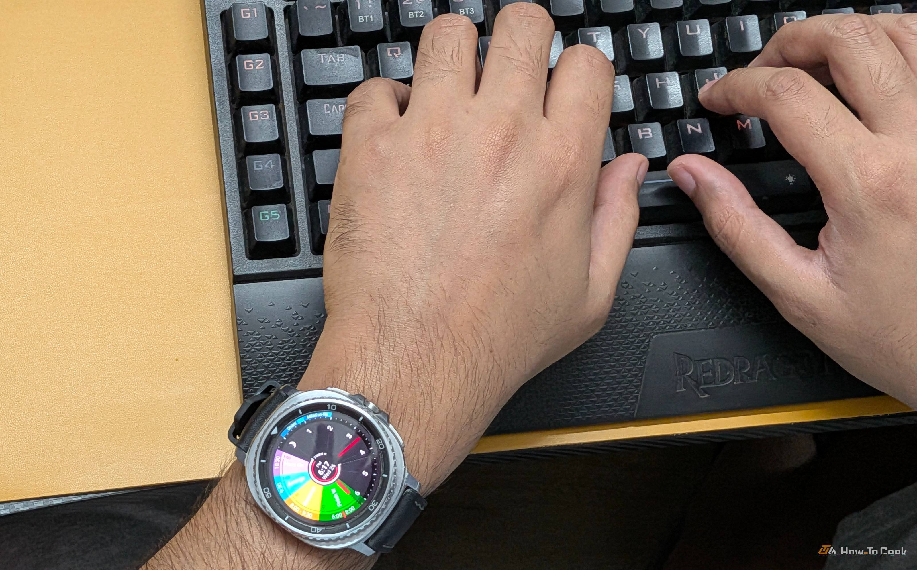Typing on a keyboard wearing a Galaxy Watch 8 Classic with Sectograph as watch face.