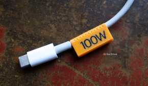 3D printed 100W orange cable clip with a thicker cable.