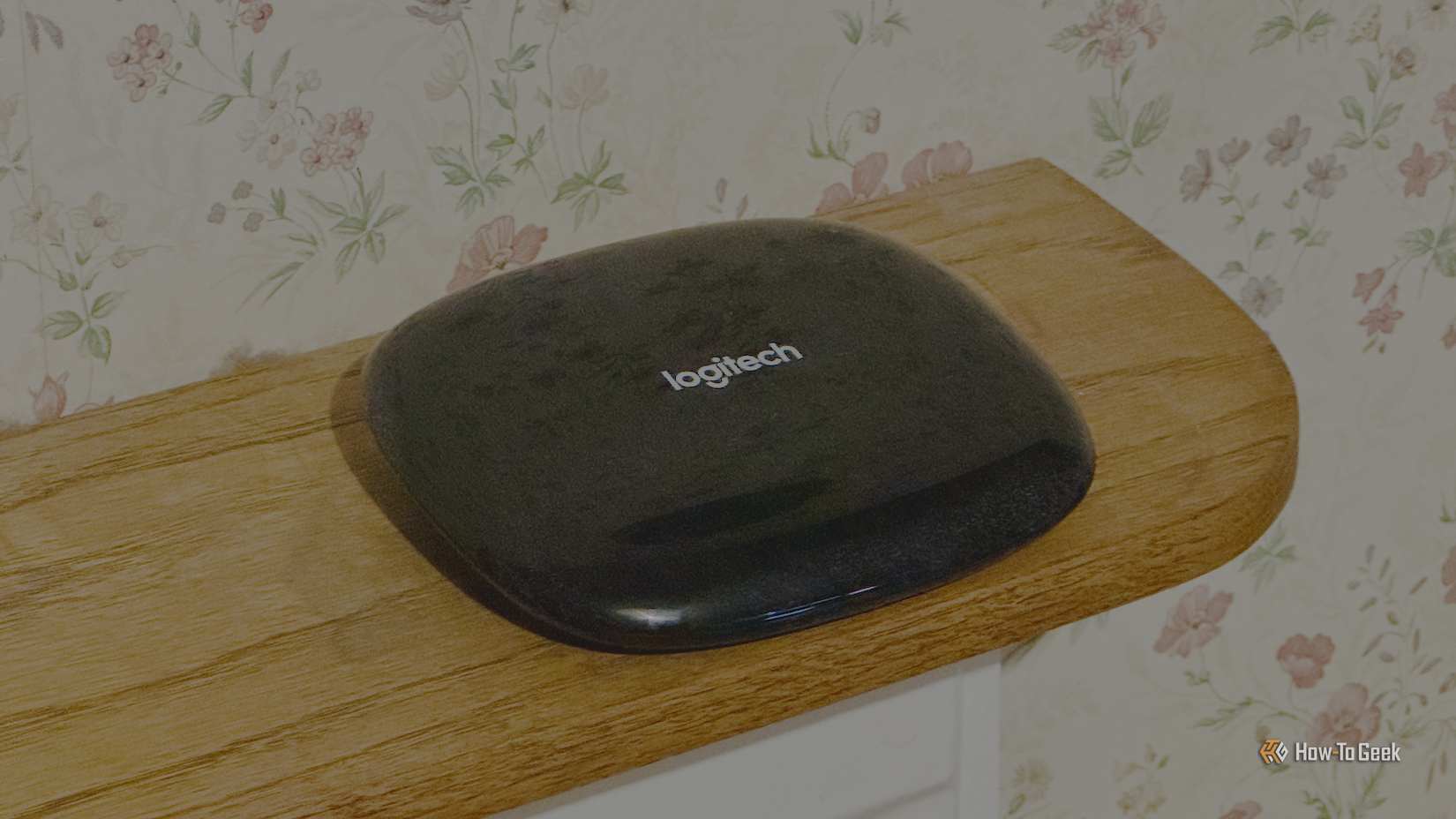 A Logitech Harmony Hub on a shelf.