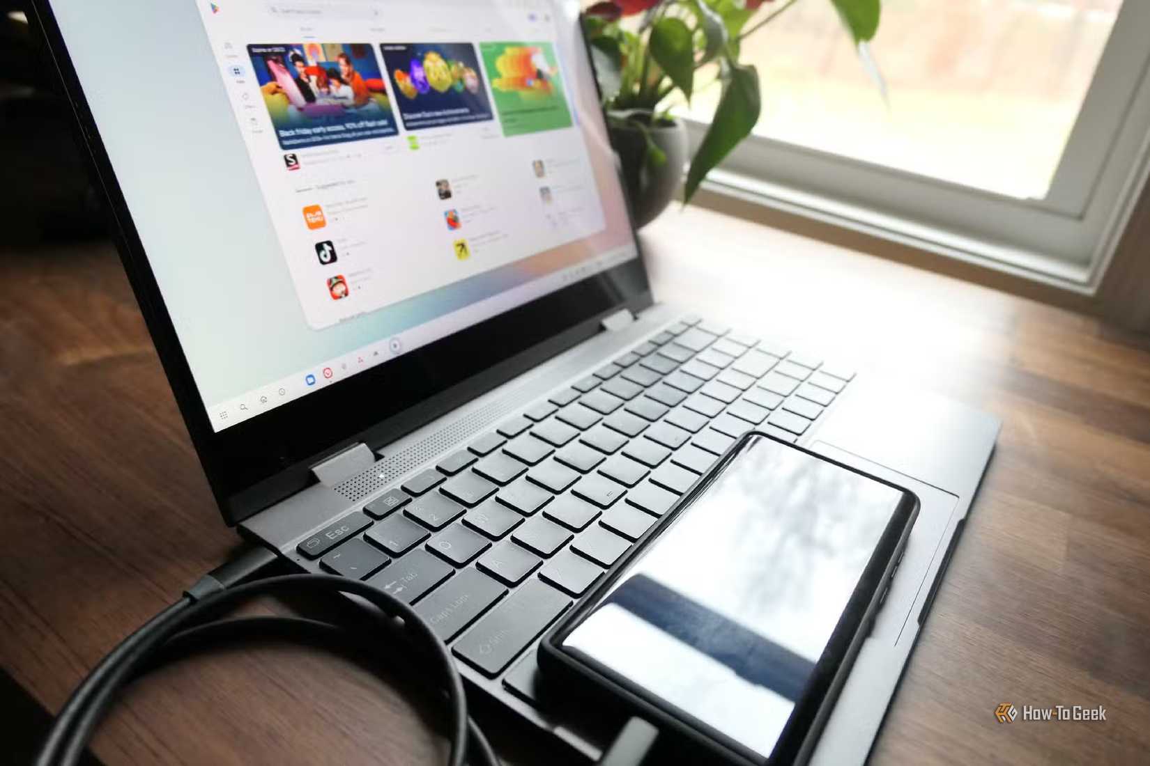 A Motorola Android phone connected to a laptop over a USB cable.
