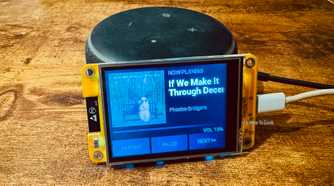 Cheap Yellow Display mounted on an Echo speaker showing a Now Playing screen for a Phoebe Bridgers track with the title cut off by the screen width.