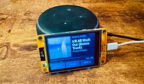 Cheap Yellow Display mounted on an Echo speaker showing a Now Playing screen for the Phoebe Bridgers bonus track Itll All Work Out.