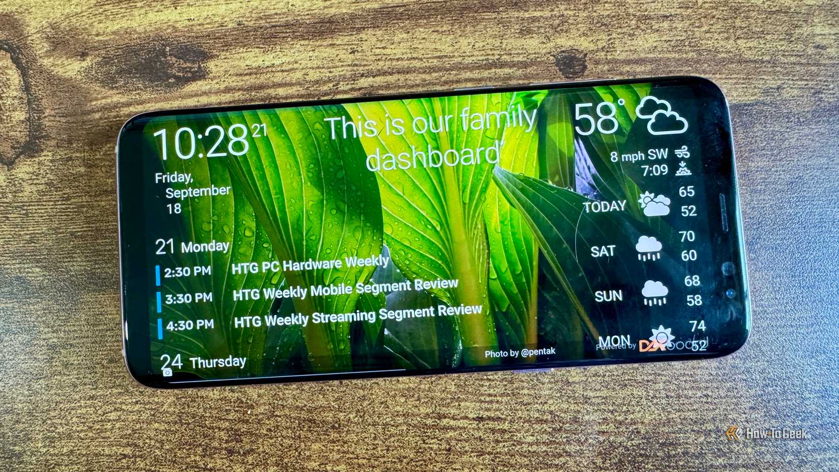 DAKboard family dashboard on an Android phone showing the calendar weekly schedule and weather forecast.