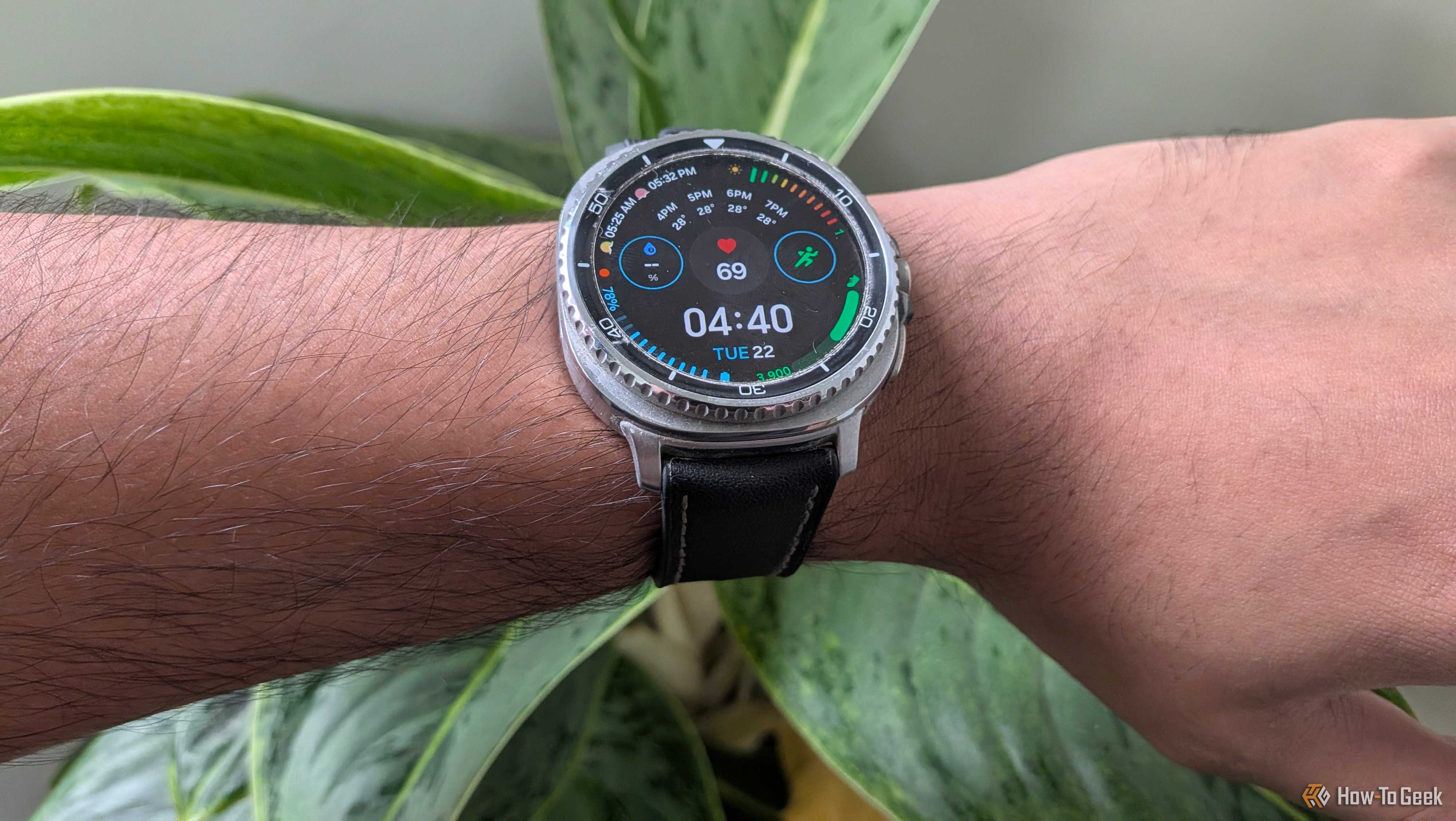 Galaxy Watch 8 Classic worn on the wrist showing a data-heavy watch face with 69 bpm heart rate and a 78 percent battery indicator.