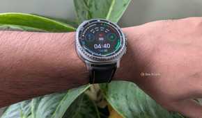 Galaxy Watch 8 Classic worn on the wrist showing a data-heavy watch face with 69 bpm heart rate and a 78 percent battery indicator.