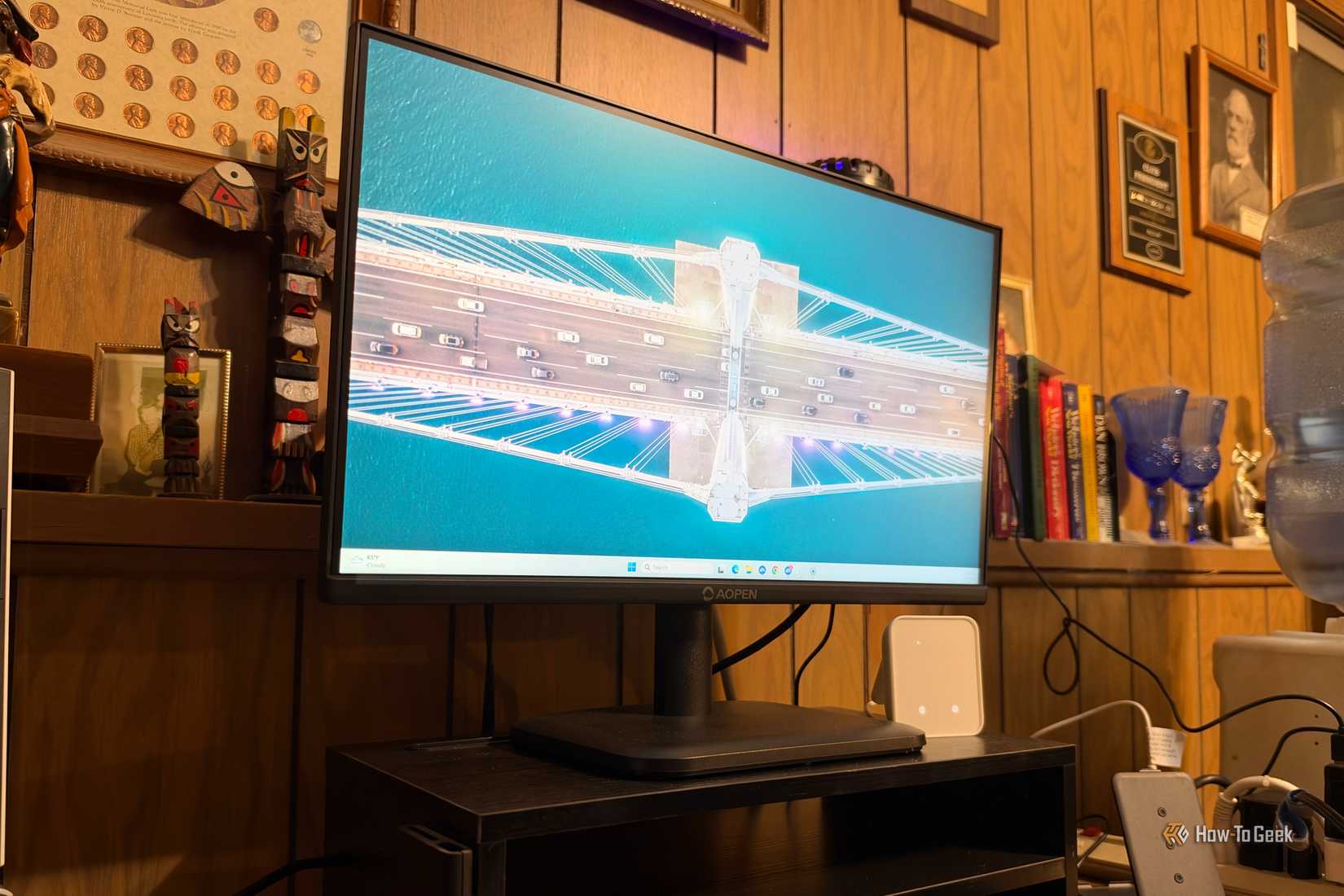 Monitor on stand on a desk.