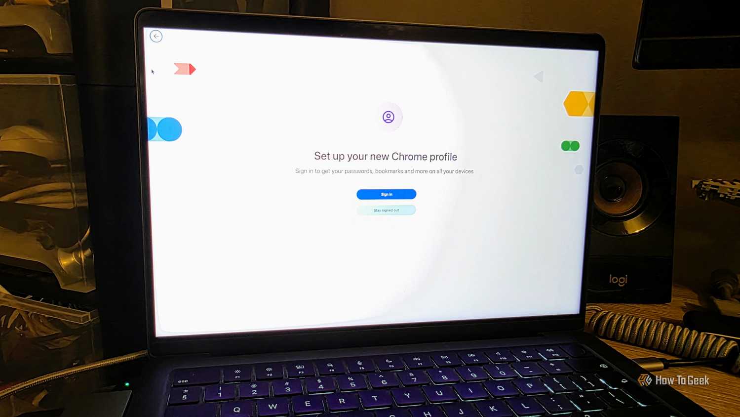 A MacBook on a desk displaying the screen for creating a new Chrome Profile.
