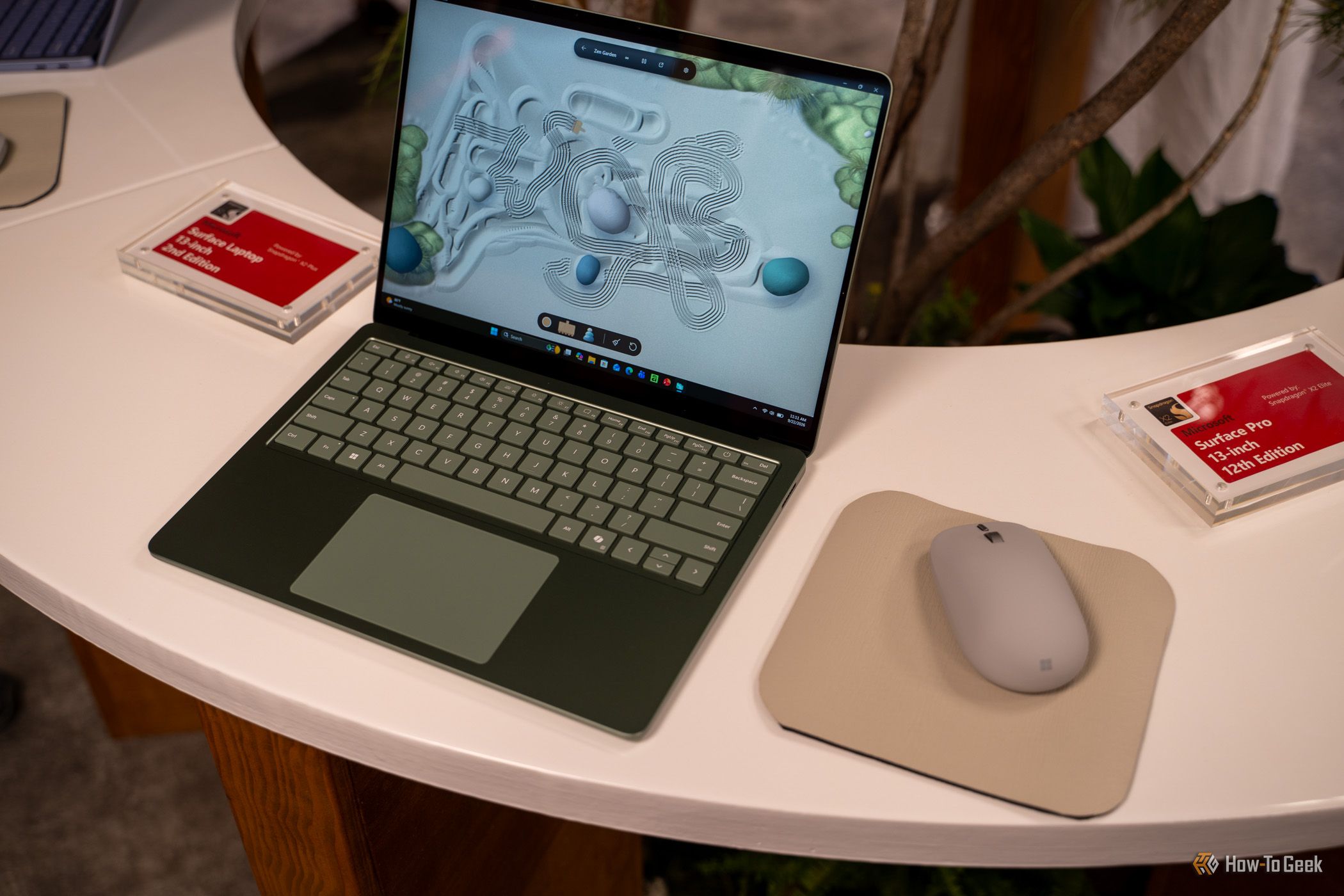 Microsoft Surface Laptop 13-inch 2nd Edition green model beside Surface Mouse.