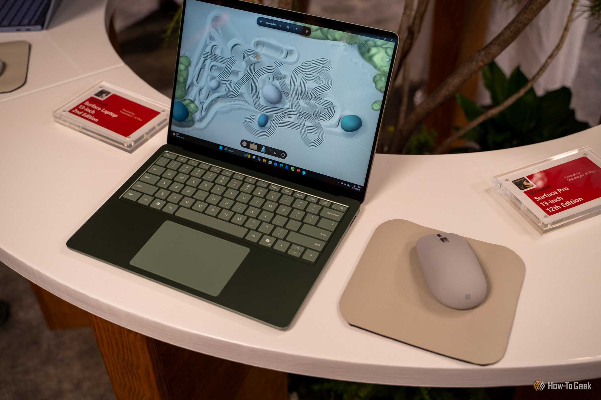 Microsoft Surface Laptop 13-inch 2nd Edition green model beside Surface Mouse.
