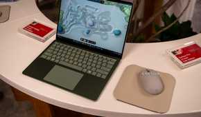 Microsoft Surface Laptop 13-inch 2nd Edition green model beside Surface Mouse.