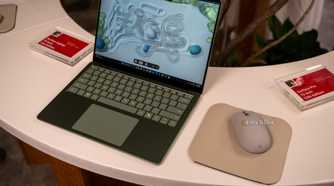 Microsoft Surface Laptop 13-inch 2nd Edition green model beside Surface Mouse.