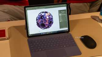 Microsoft Surface Pro 12-inch 2nd Edition with purple keyboard showing Photoshop artwork.