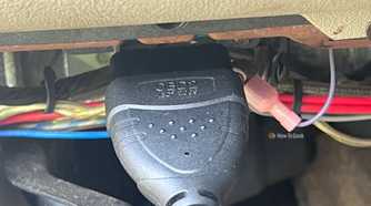 An OBD-II scanner cable plugged into the vehicle's diagnostic port.
