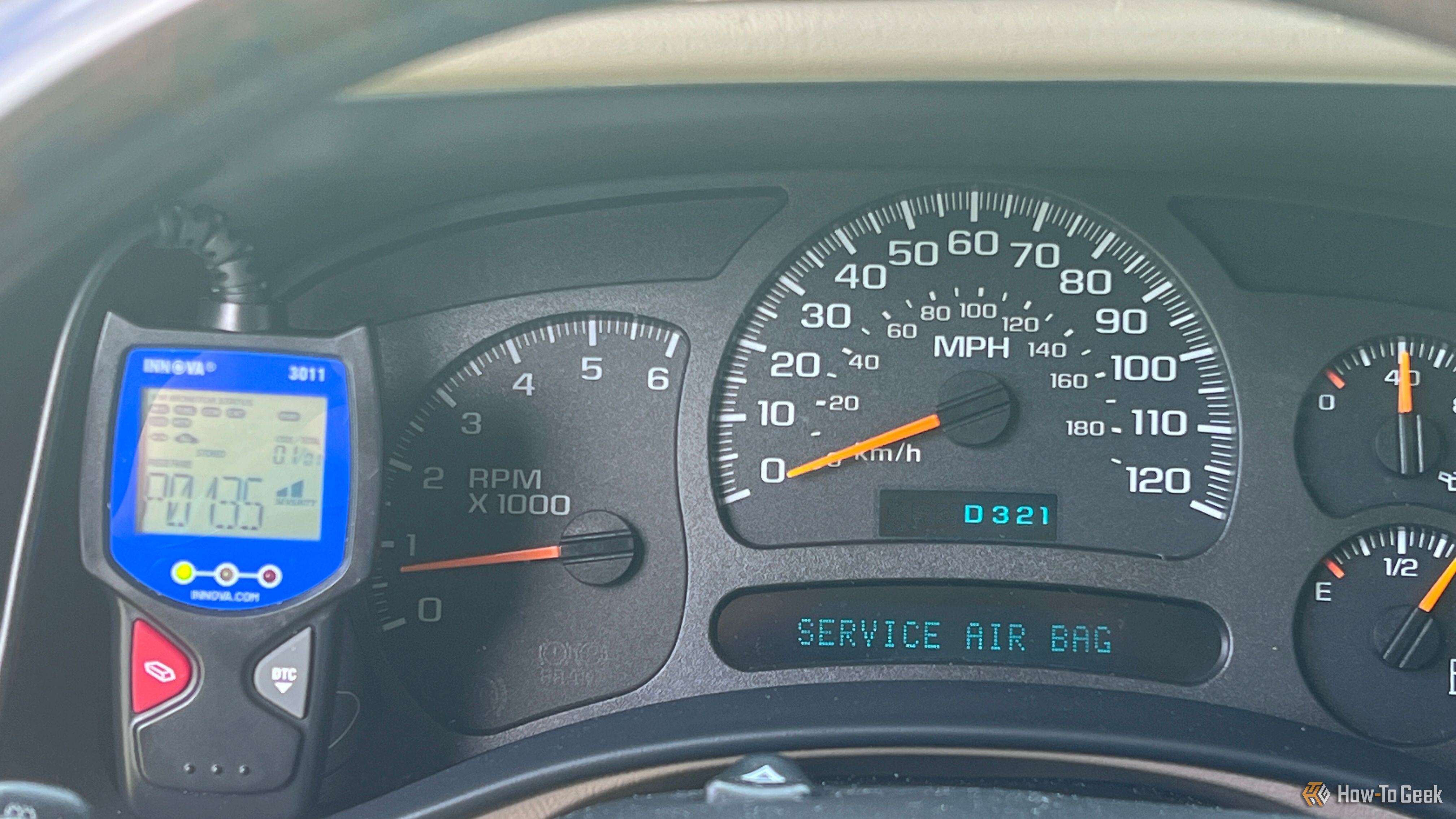 An Innova 3011 OBD-II scanner connected beside the dashboard cluster.