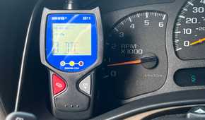 An Innova 3011 OBD-II scanner displaying diagnostic information in a vehicle.