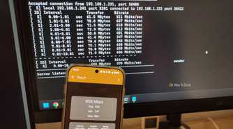 A phone with iPef3 test running with the PC in the background.