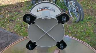 Photo showing the bottom of a Ridgid wet/dry vac, displaying the wheels for easier portability when blowing or sucking up debris