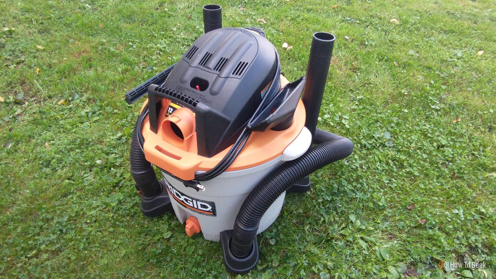 photo of a Ridgid wet/dry vac with accessories pictured in the grass