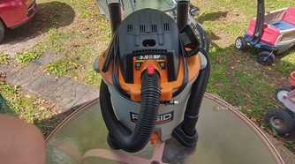 Photo of a Ridgid wet/dry vac on a table with accessories mounted