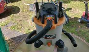 Photo of a Ridgid wet and dry vac sitting on an outdoor table with all included accessories