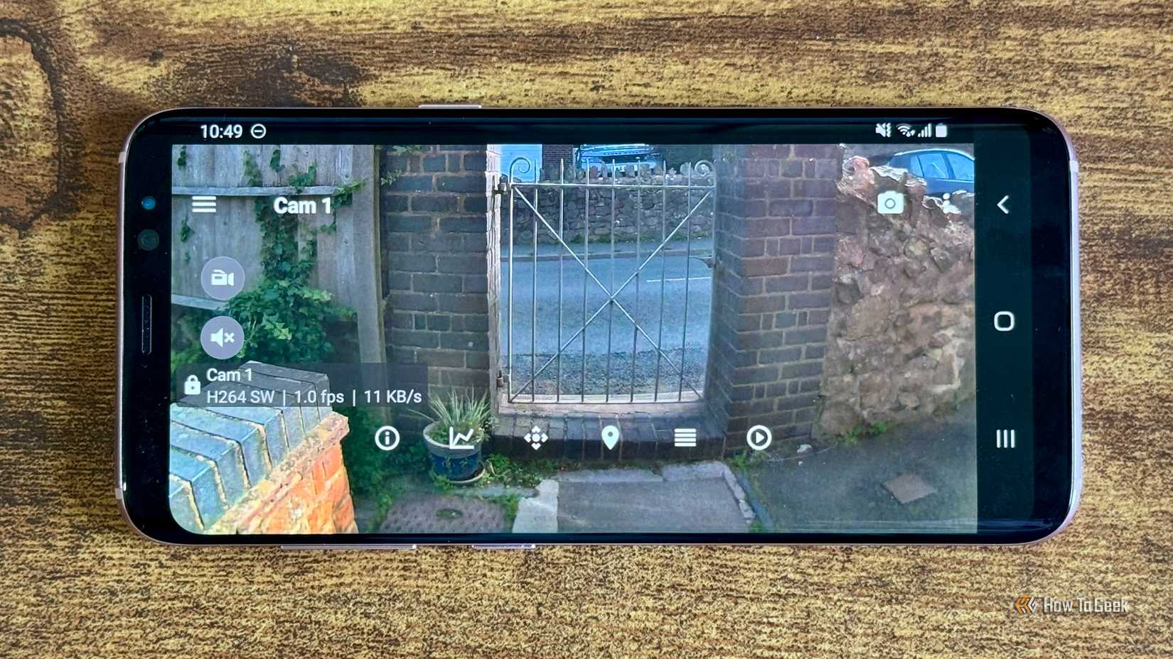 tinyCam Monitor security camera feed on an Android phone showing a front gate and driveway.