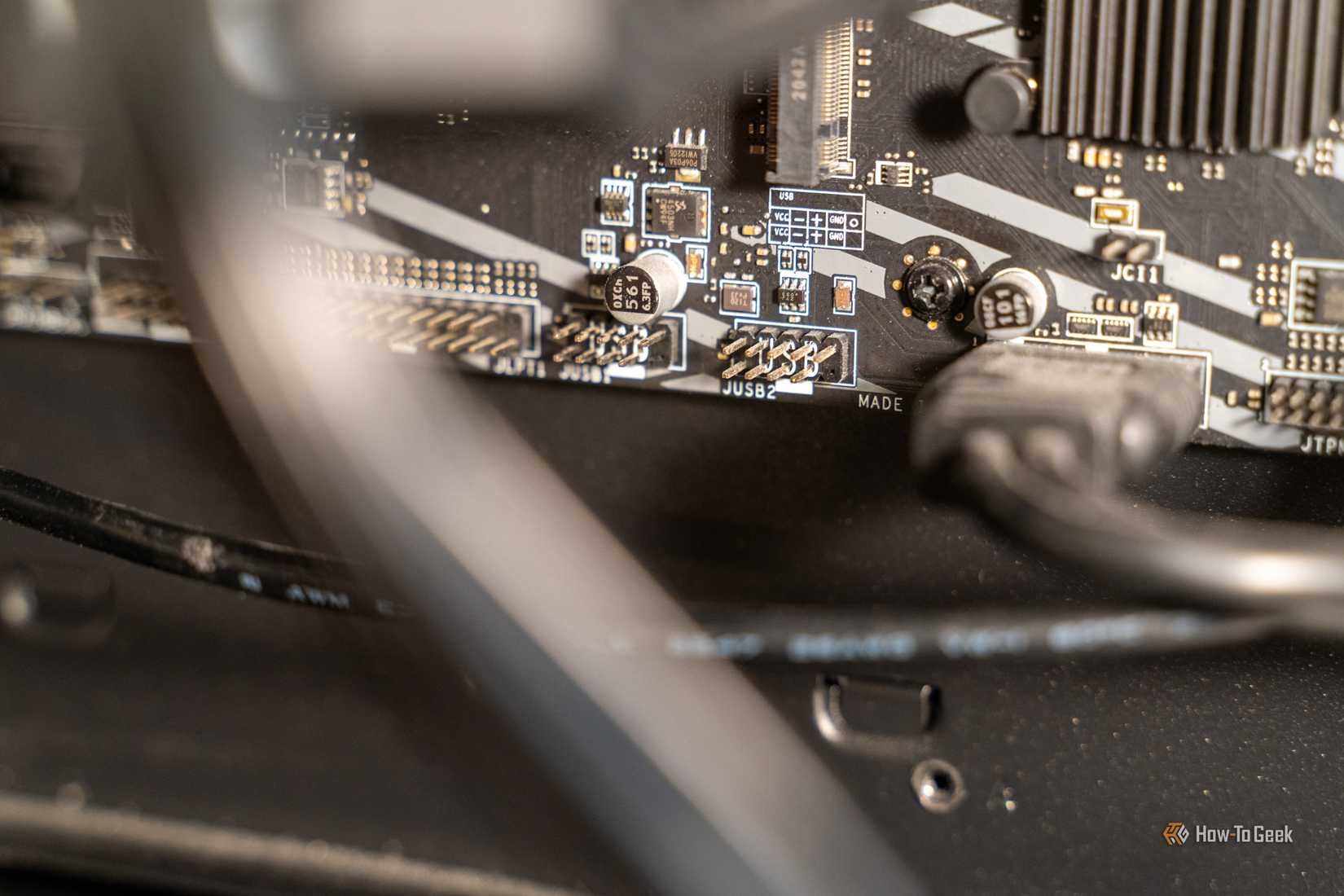 Unused motherboard USB 2.0 headers with JUSB2 label and pinout diagram viewed at an angle.