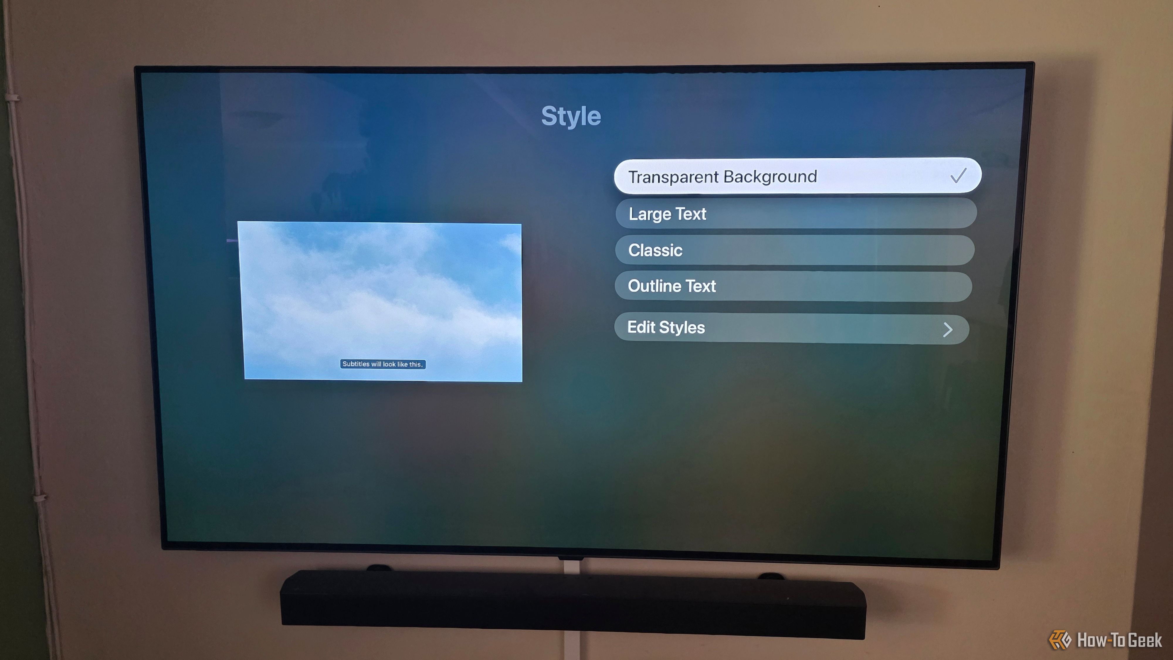 The Apple TV app is showing subtitle options to change styles with transparency selected.