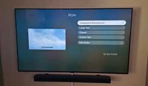 The Apple TV app is showing subtitle options to change styles with transparency selected.