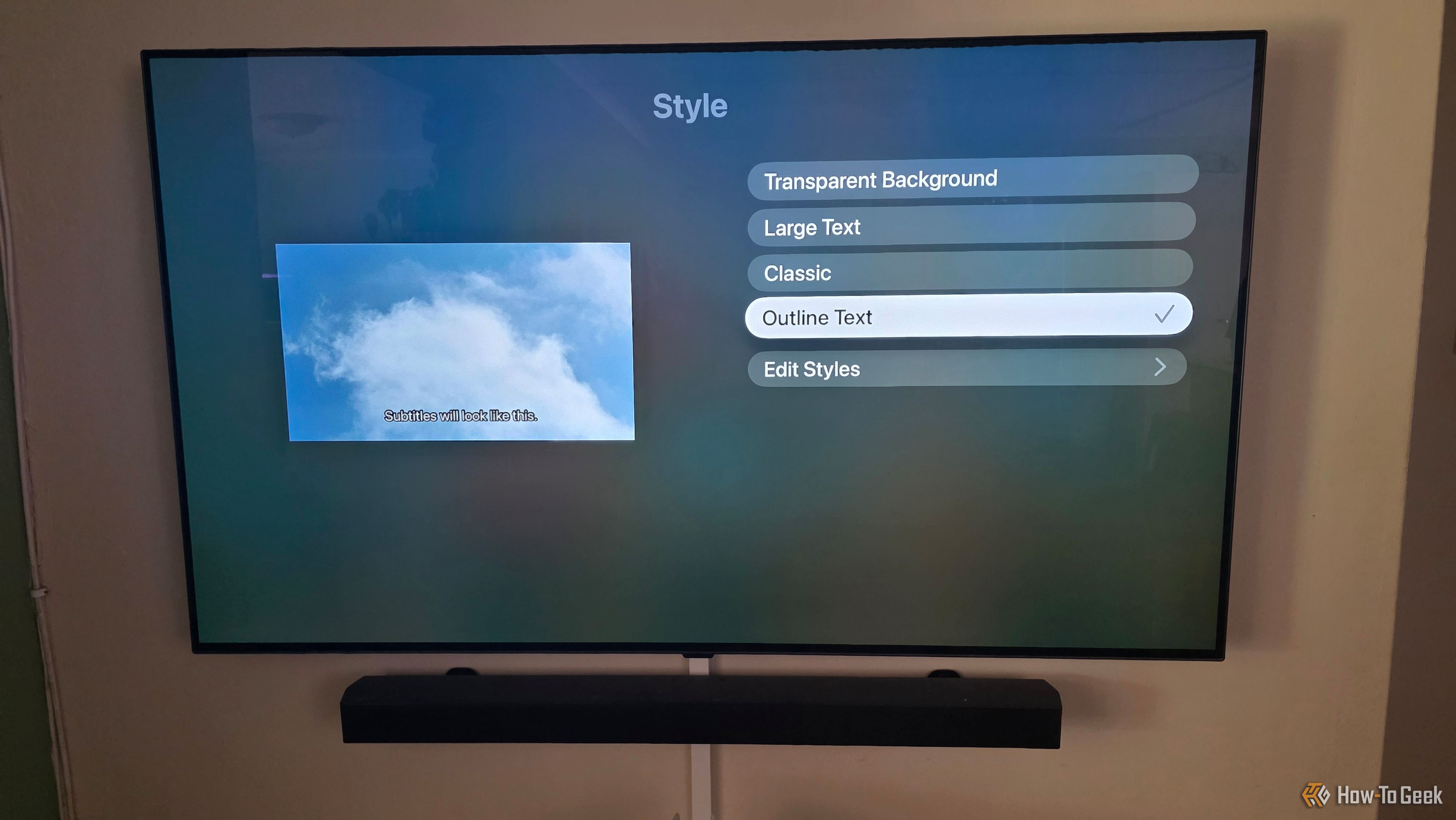 The Apple TV app is showing subtitle options to change styles with outlined text selected.