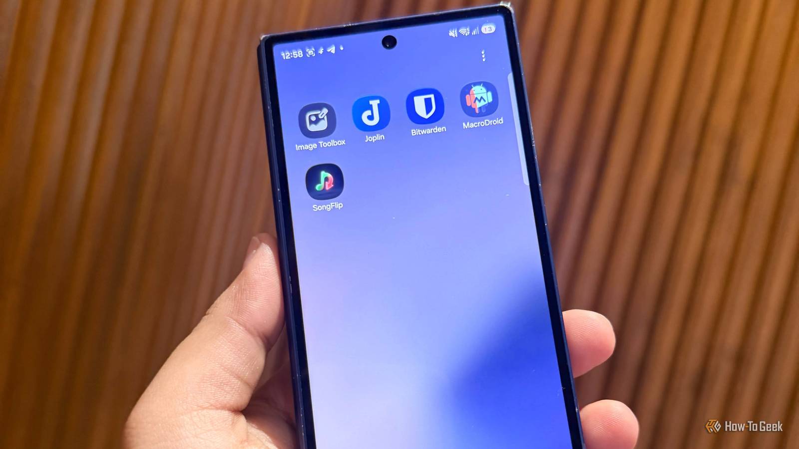 Hand holding an Android phone.