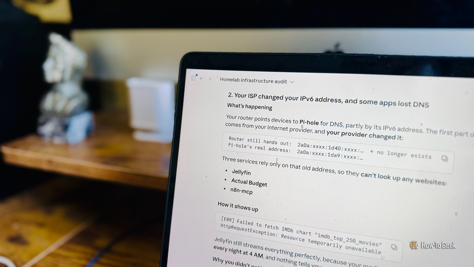 A MacBook Air showing the Claude app with the results of a homelab audit that found several issues.