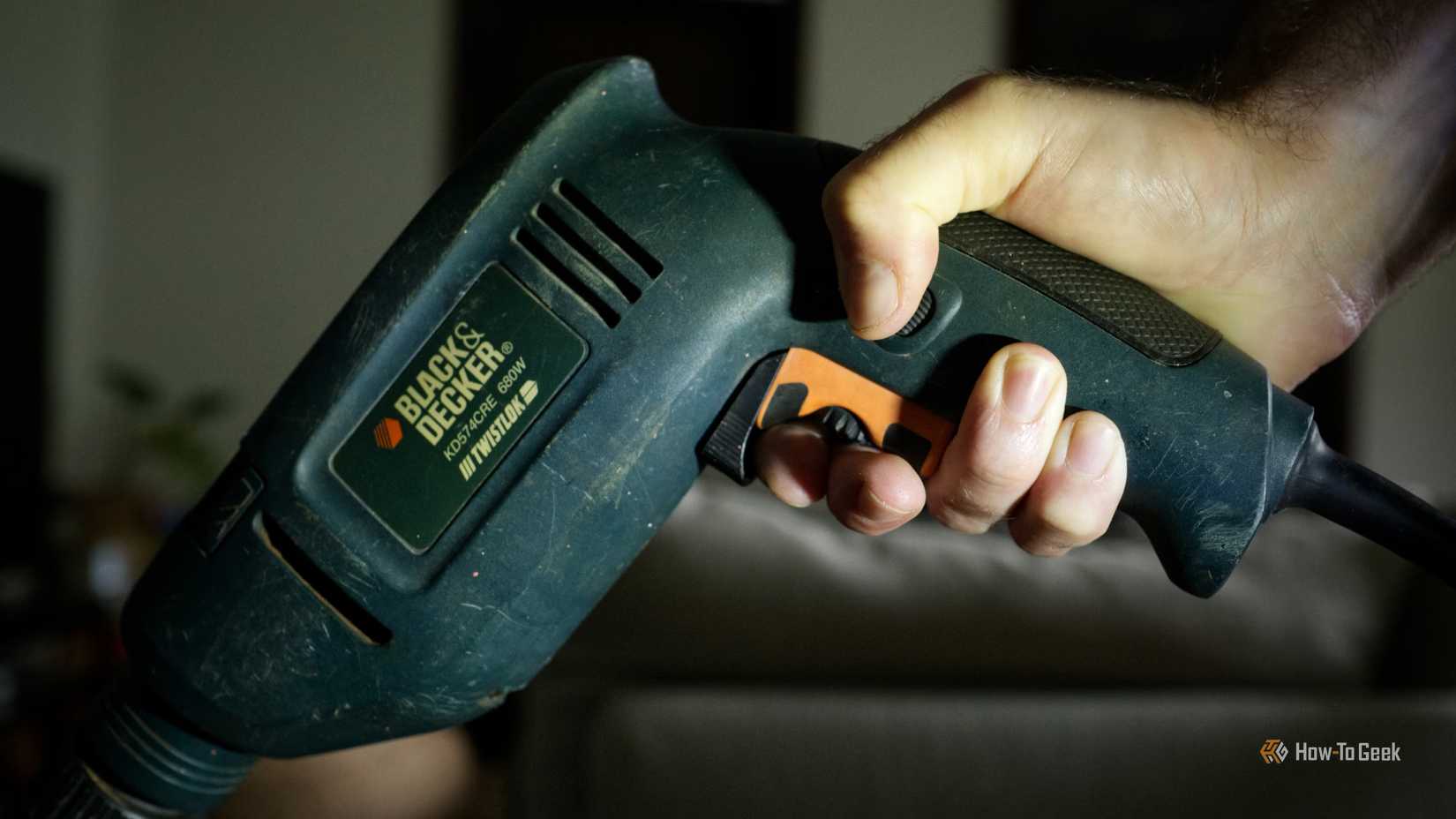 a-person-holding-a-black-decker-hammer-drill