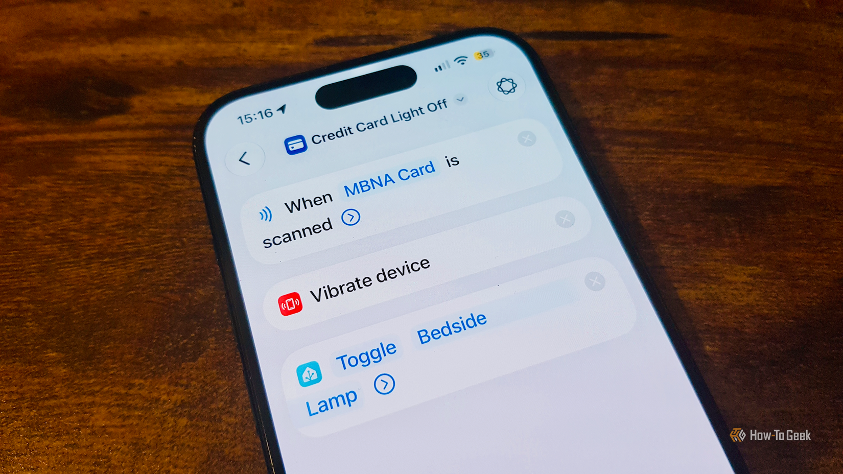 An automation in the Shortcuts app on an iPhone that toggles the bedside lamp when the NFC chip in a credit card is scanned.