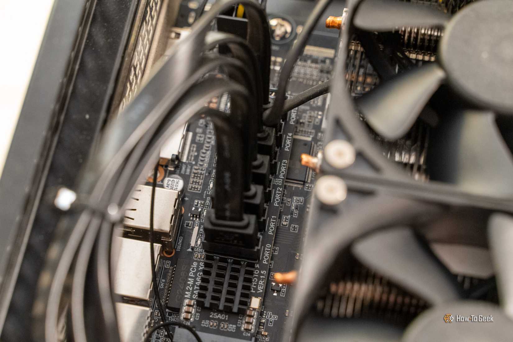 SATA cables plugged into the M.2-to-SATA adapter card on the Cephalon Lucy's motherboard.