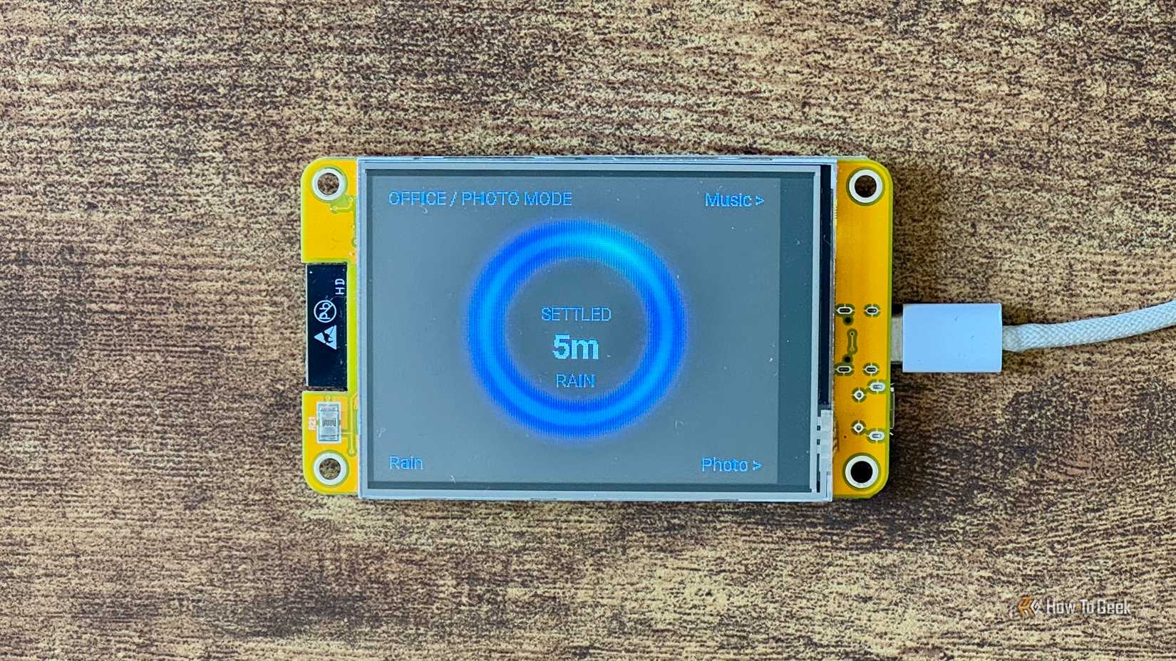 Cheap Yellow Display mood ring showing blue rain weather colors with SETTLED 5m and RAIN labels.