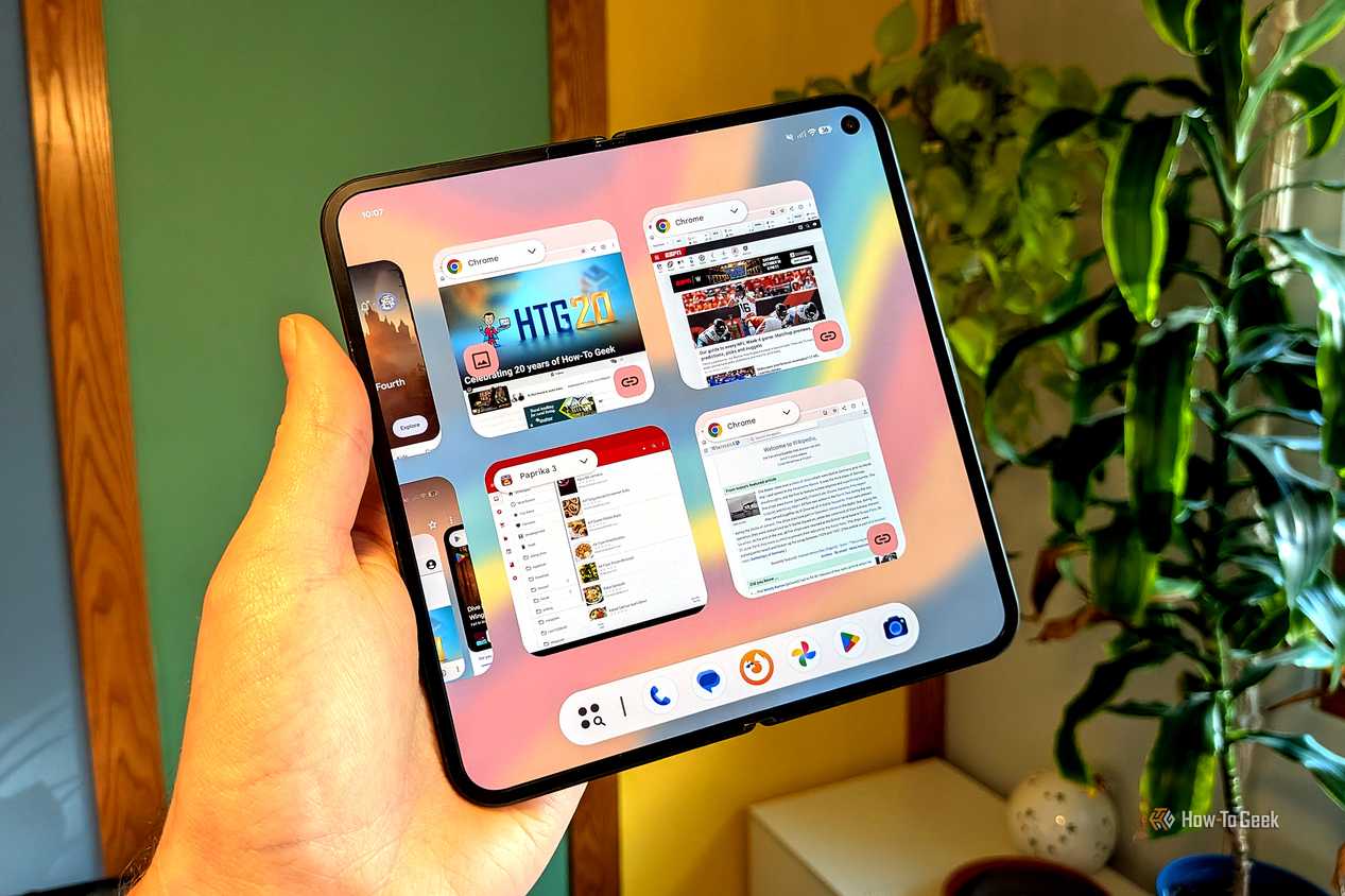 An image of a person holding a foldable phone, with Chrome open, with many tabs on screen.