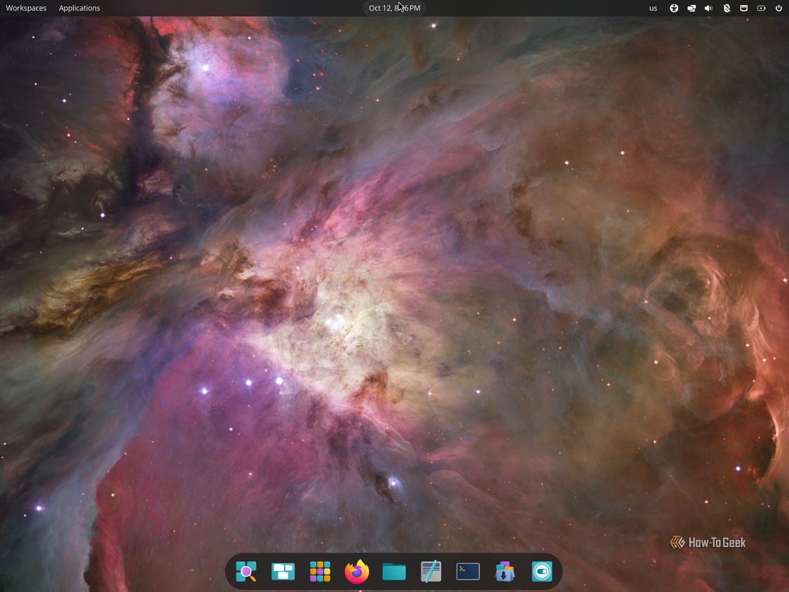 COSMIC desktop on Pop!_OS with the top panel and floating bottom dock over the Orion Nebula wallpaper.