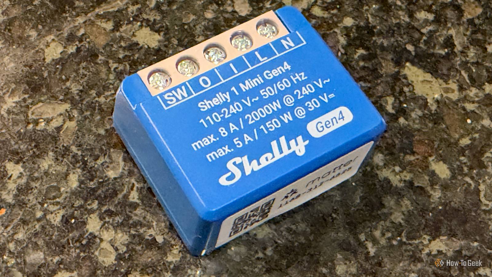 Shelly 1 Mini Gen4 Smart Relay Switch on a counter.