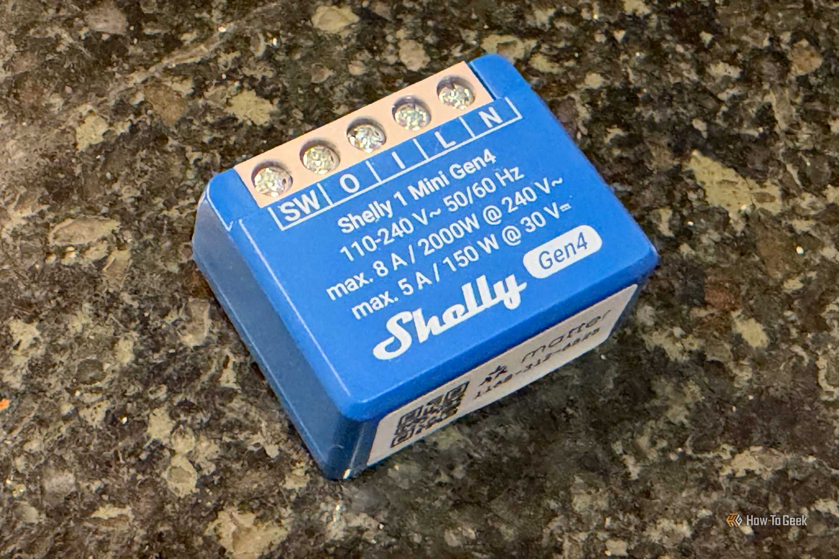 Shelly 1 Mini Gen4 Smart Relay Switch on a counter.