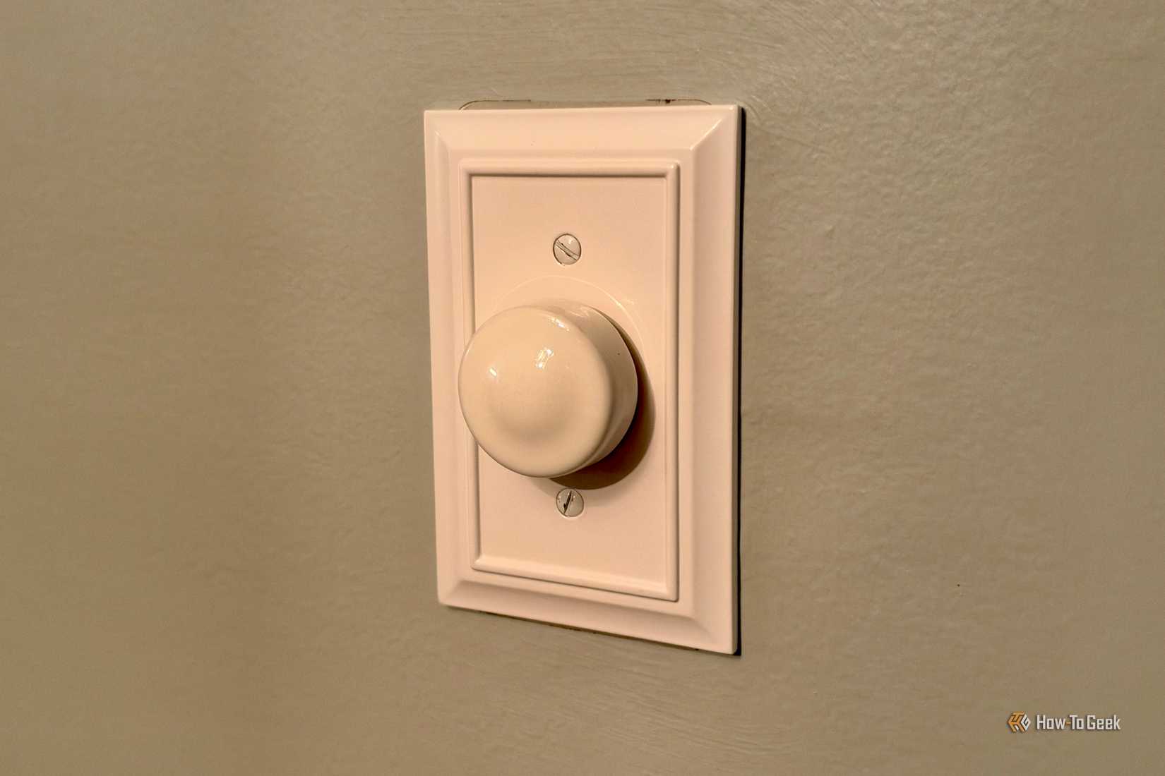 Rotary dimmer switch on the wall.
